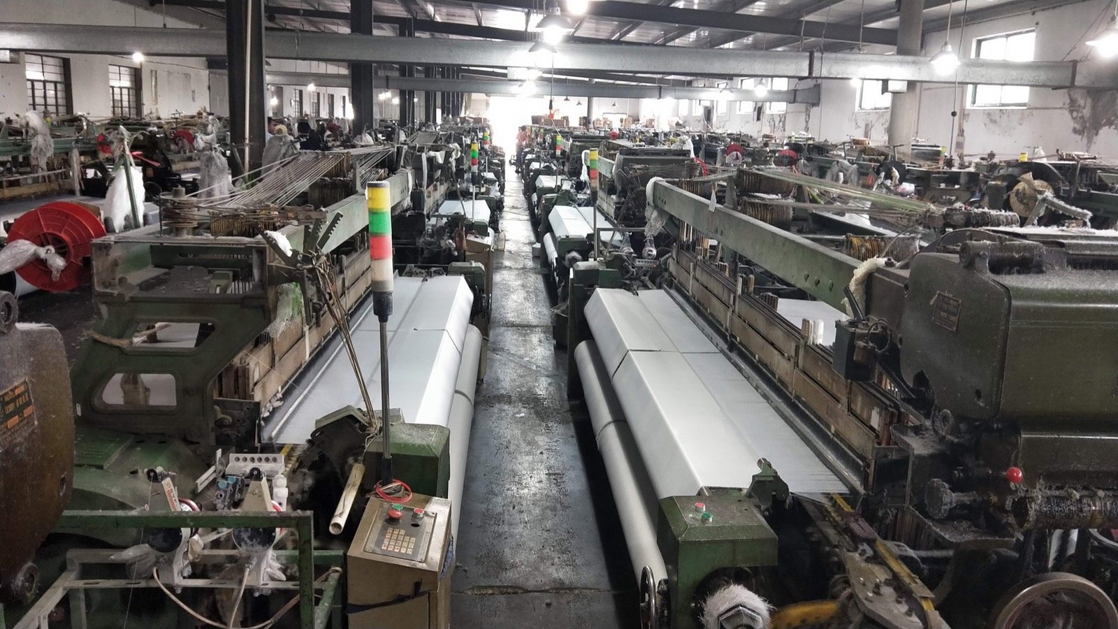 Long-running rapier looms producing fabric in a customer factory