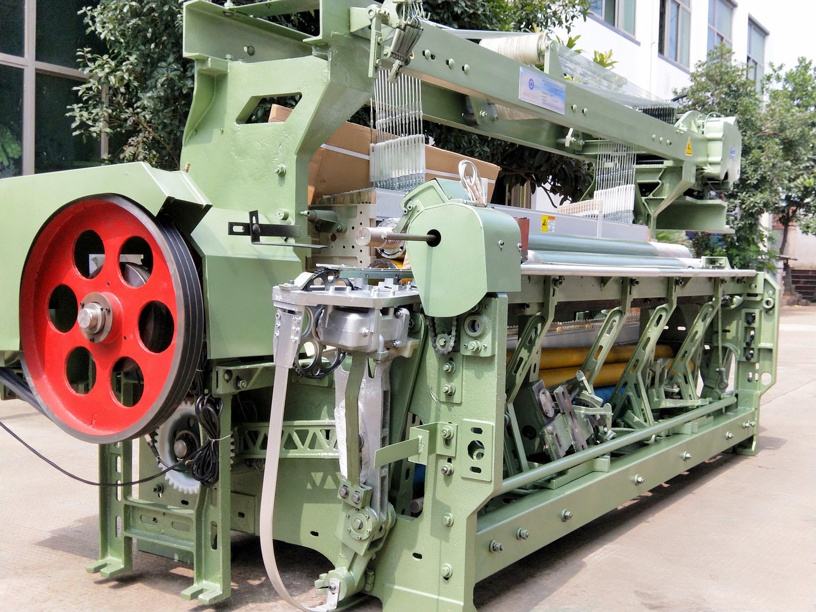 Front view of MG788 rapier loom showing the reed area, cloth rollers and side drive
